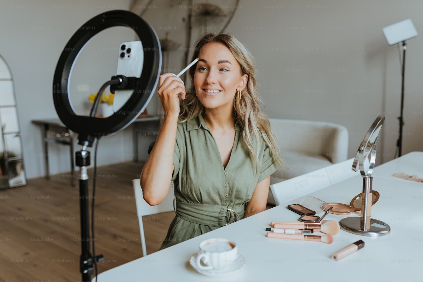 Seller presenting products to a phone camera on a ring light