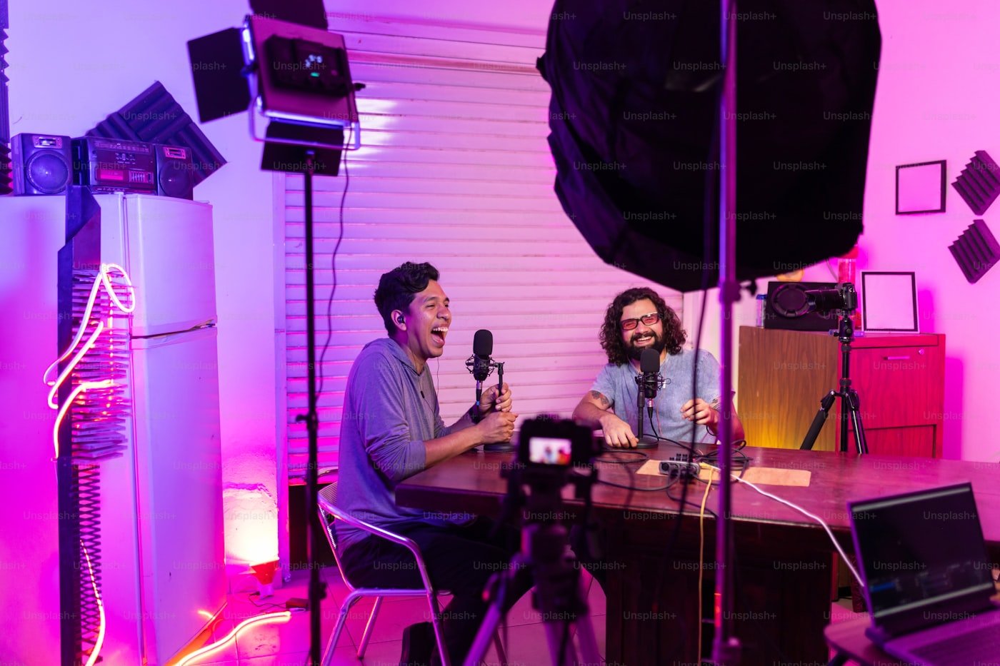 Creators filming in a studio lit with colored lights
